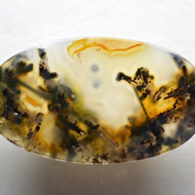 A piece of agate with black and yellow swirls.