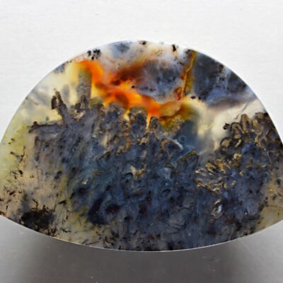 A piece of agate with an orange and black pattern.