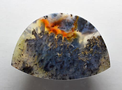 A piece of agate with an orange and black pattern.