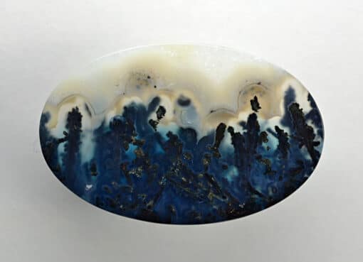 A blue and white agate on a white surface.