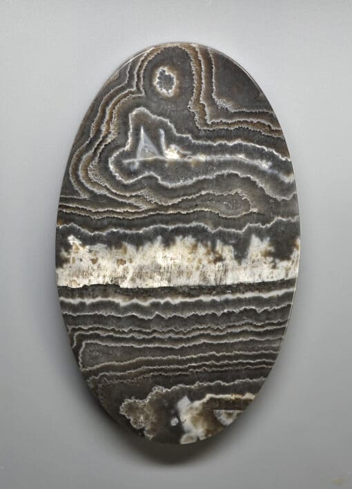 A black and white agate oval on a white background.
