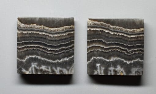 Two pieces of agate on a white surface.