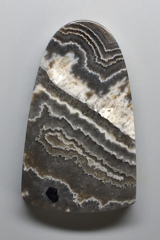 A piece of agate with a black and white pattern.