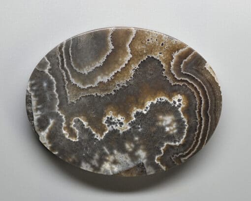 A round piece of agate on a white surface.