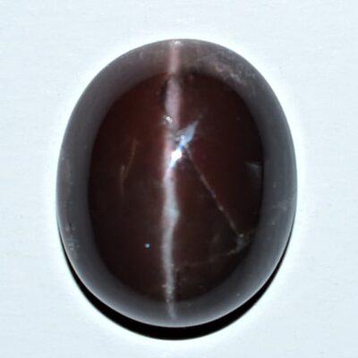 A brown tiger eye stone on a white surface.