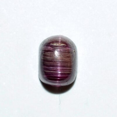 A purple and brown striped bead on a white surface.