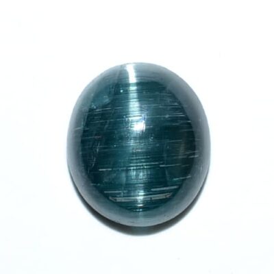 An oval shaped green stone on a white surface.