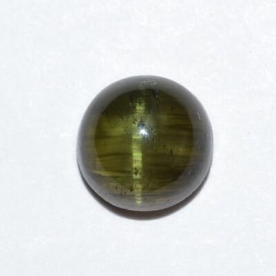 A green stone on a white surface.