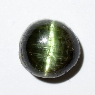 A green stone on a white surface.