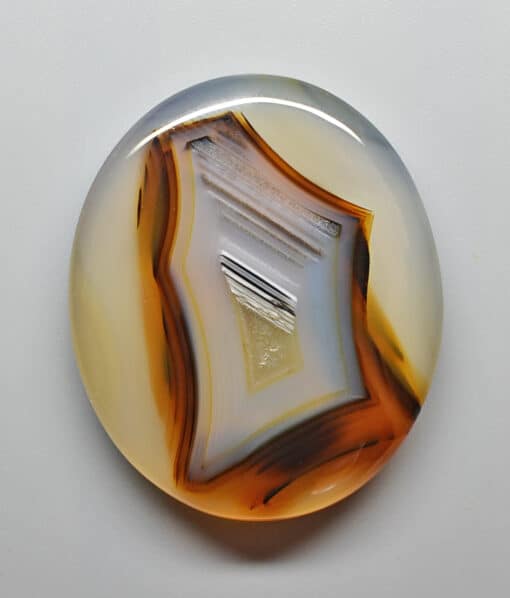 A round piece of agate on a white surface.