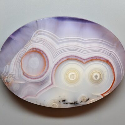 A plate with a purple and orange agate on it.