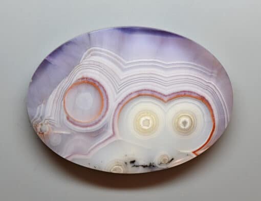 A plate with a purple and orange agate on it.