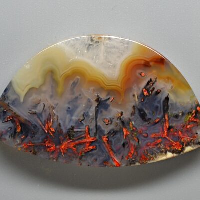 A piece of agate with red and orange colors.