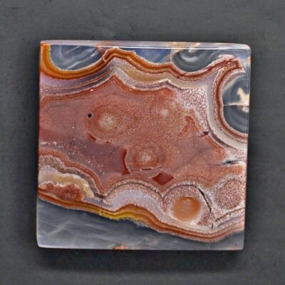 A piece of agate on a black surface.