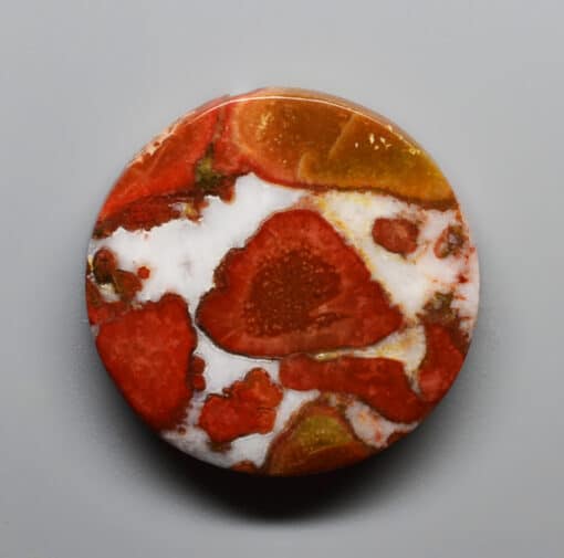 A red and white cabochon on a white background.