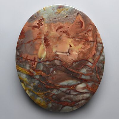 A round piece of marble with brown and orange swirls on it.