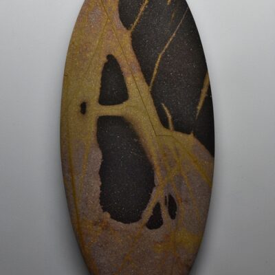 A stone with a black and yellow pattern on it.