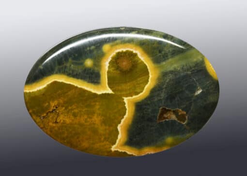 A round piece of green and yellow agate.