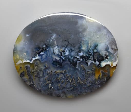 A blue and yellow agate plate on a white surface. Purchase Gems to get a Discount.