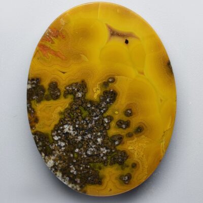 A yellow and black agate plate on a white surface.