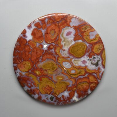 An orange and yellow marble plate on a white surface.