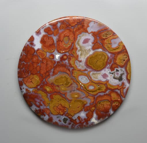 An orange and yellow marble plate on a white surface.