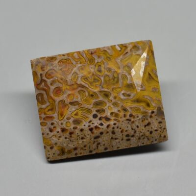 A square piece of yellow and brown agate.