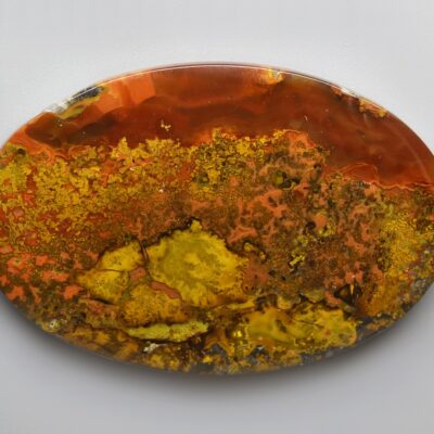 A piece of orange and yellow agate on a white background.