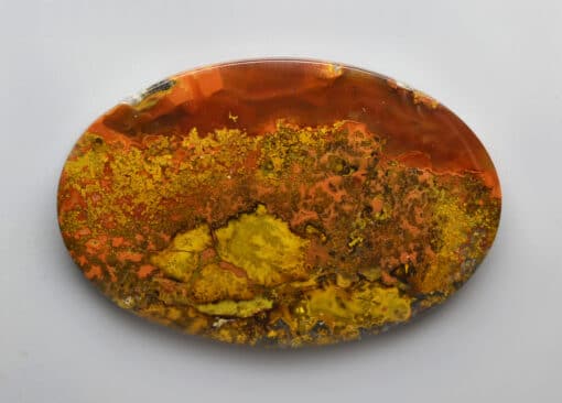 A piece of orange and yellow agate on a white background.