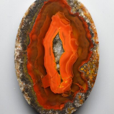 A piece of orange agate on a white background.