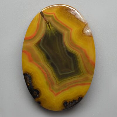 A yellow agate on a white surface.