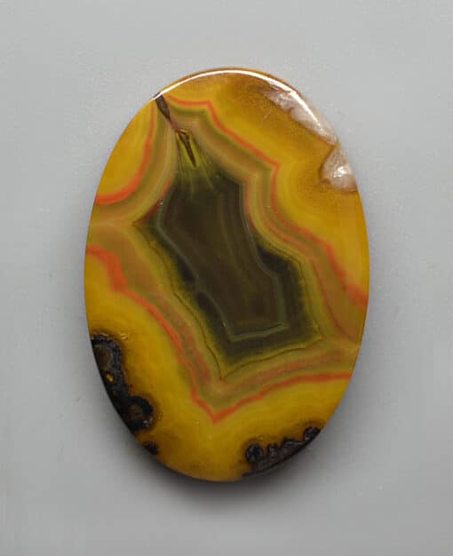 A yellow agate on a white surface.