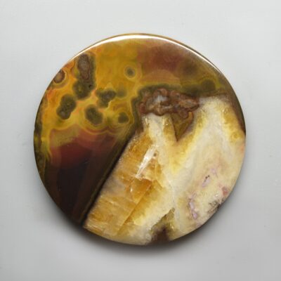 A round piece of agate on a white surface.
