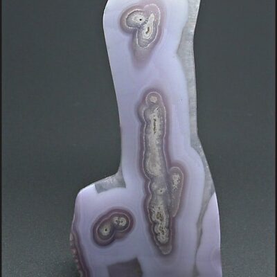 A piece of purple agate on a black surface.