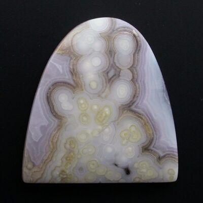 A piece of agate on a black surface.