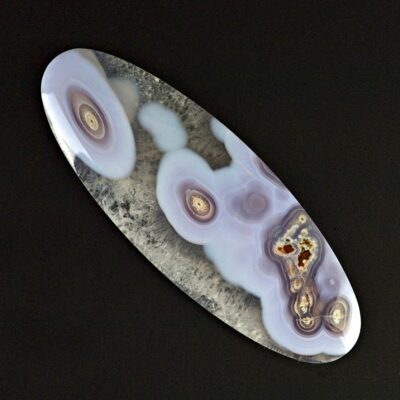 A piece of agate on a black surface.