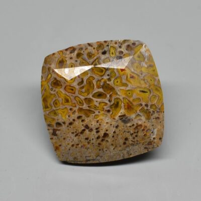 A yellow and brown stone cabochon.