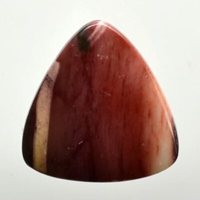 A piece of red jasper on a white background.