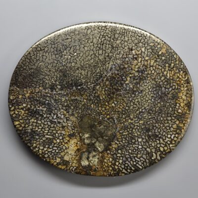 A plate with a gold and black pattern on it.