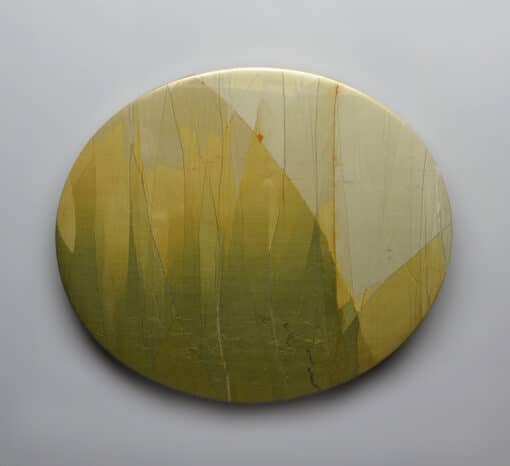 A yellow and green circular painting on a white background.