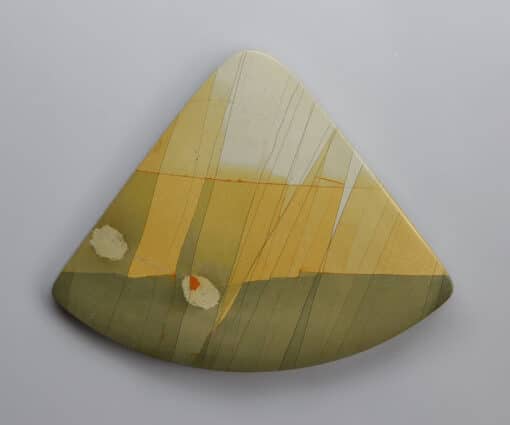 A triangular piece of art with a yellow and green design.