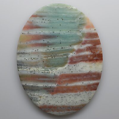 A circular piece of colored marble on a white surface.
