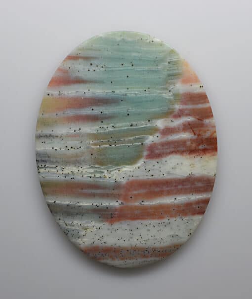 A circular piece of colored marble on a white surface.