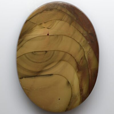 A circular piece of brown and yellow marble on a white surface.