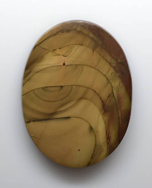 A circular piece of brown and yellow marble on a white surface.
