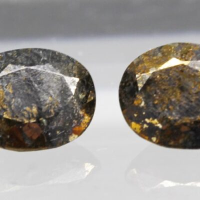 A pair of brown and yellow diamond stud earrings.
