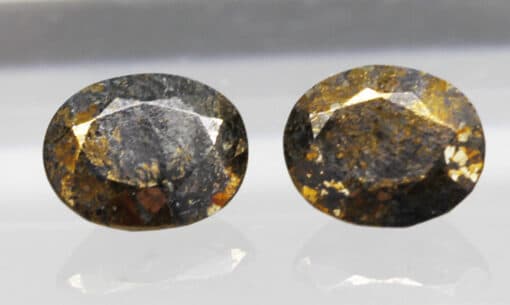 A pair of brown and yellow diamond stud earrings.