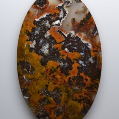 A piece of agate with orange and brown spots on it.