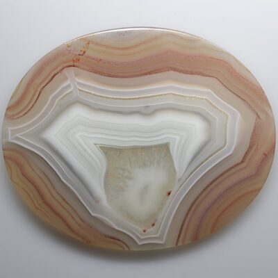 A round piece of agate on a white surface.