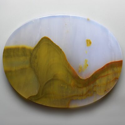 A yellow and white agate plate on a white surface.